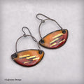 Enamel dangle earrings with teardrop orange-red panels and gold-tone striped accents