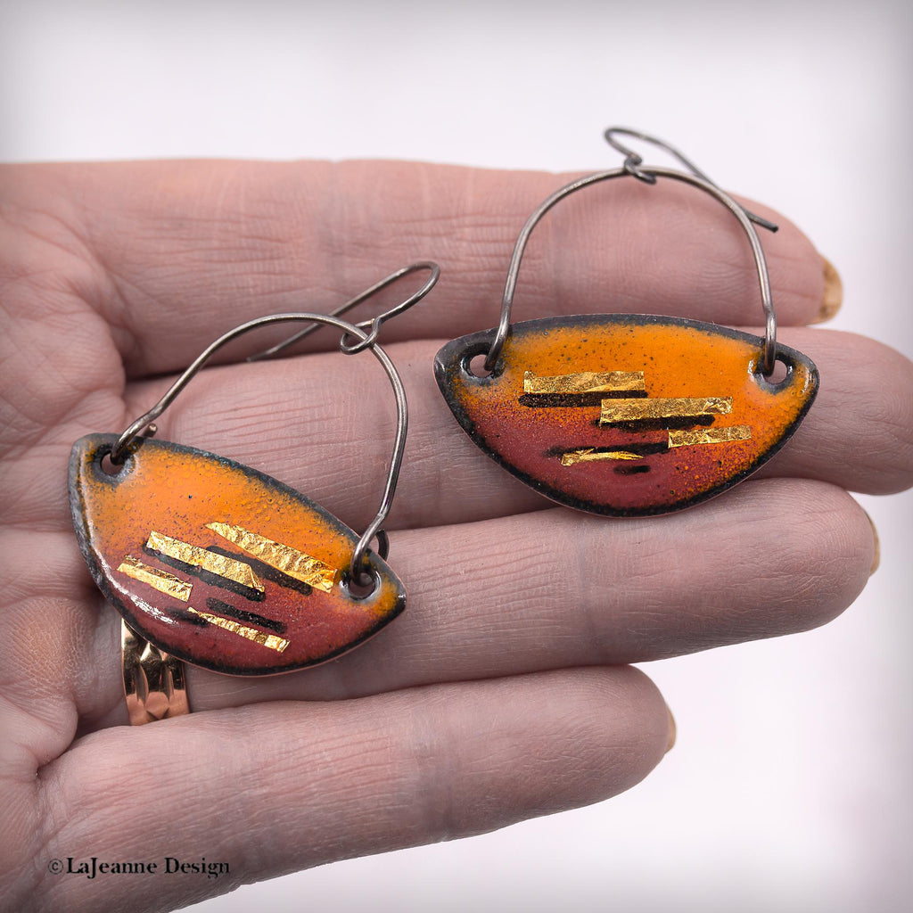 Enamel dangle earrings, two teardrop orange-red pieces with gold-tone stripe bars