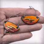 Enamel dangle earrings, two teardrop orange-red pieces with gold-tone stripe bars