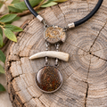Bone and fossil shell pendant necklace with black cord and silver-tone hardware