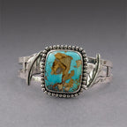 Turquoise oval cabochon bracelet with silver scalloped bezel and hinged side accents