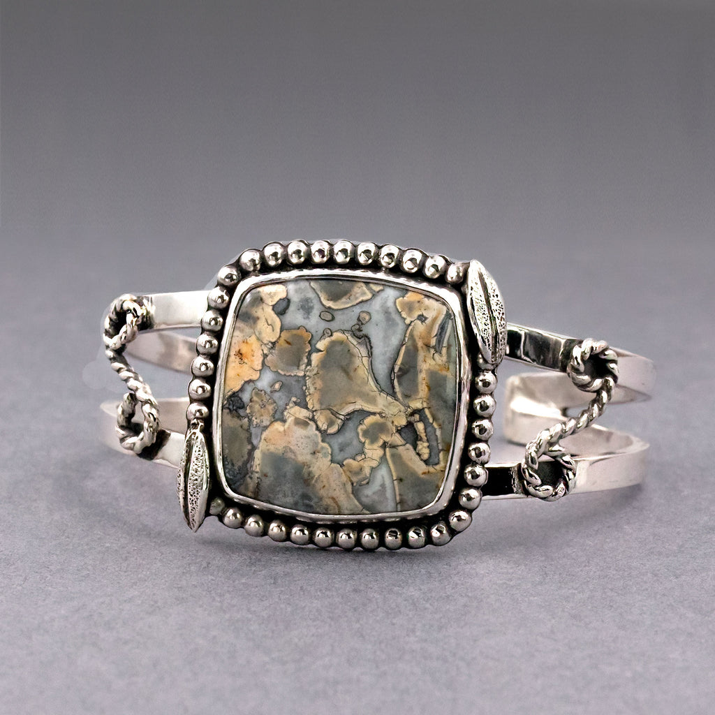 Sterling silver cuff with rectangular jasper cabochon, bead frame and twisted chain sides.