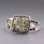 Sterling silver cuff with rectangular jasper cabochon, bead frame and twisted chain sides.