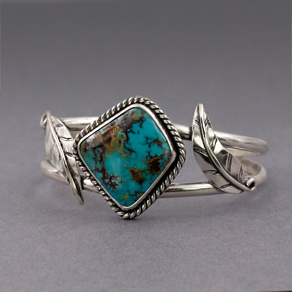 Sterling silver cuff bracelet with turquoise square center stone and rope trim