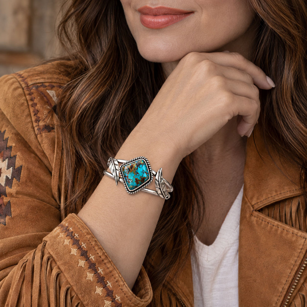 Sterling silver cuff bracelet with turquoise oval stone and braided border