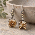Dendritic agate earrings with round brown-and-white stones, silver settings, and gold accents