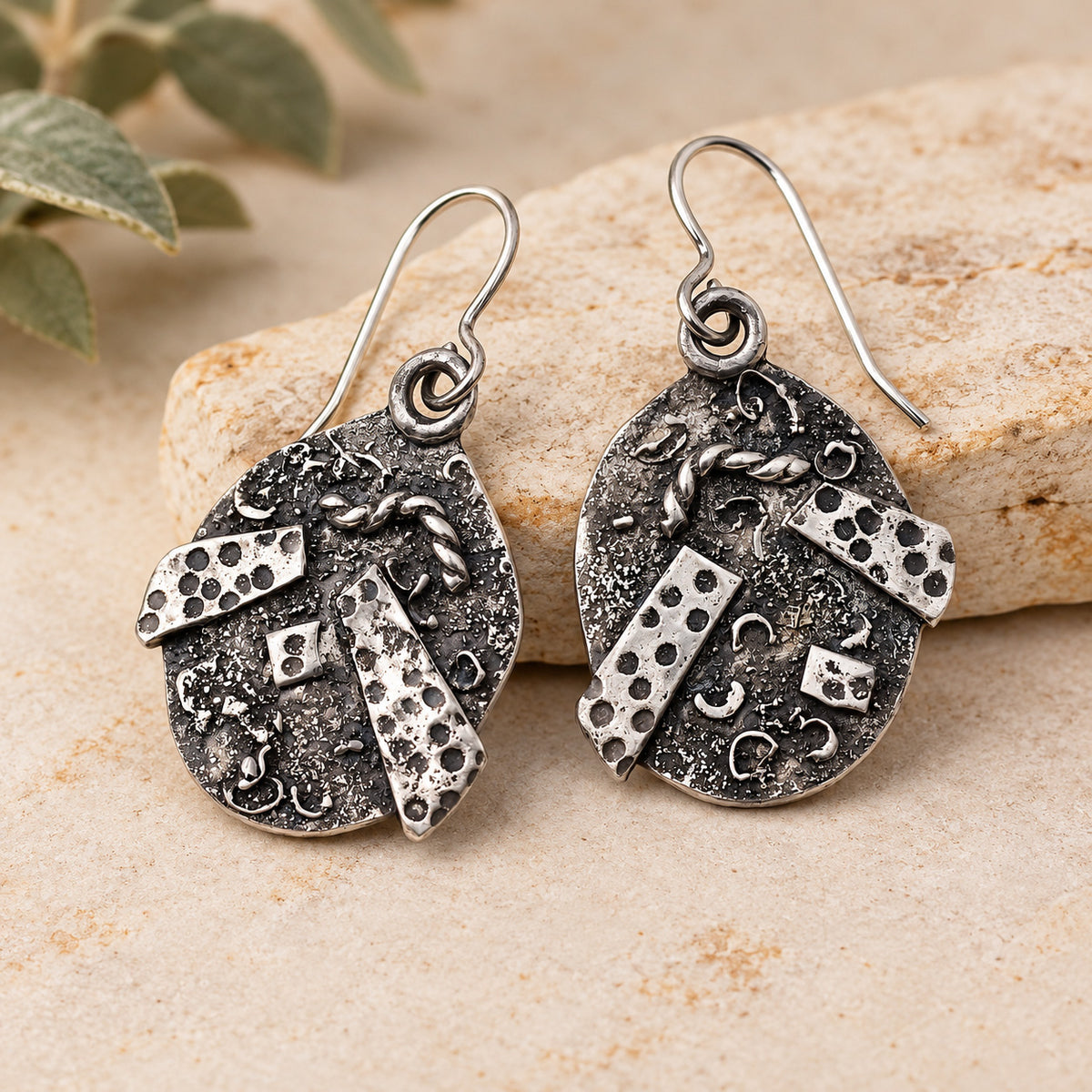 Textured sterling silver drop earrings with round, patterned pendants and hook backs