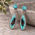 Sterling silver drop earrings with round turquoise stones and elongated blue opalized wood inlays