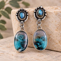 Sterling silver drop earrings with blue opalized wood stones and beaded oval studs