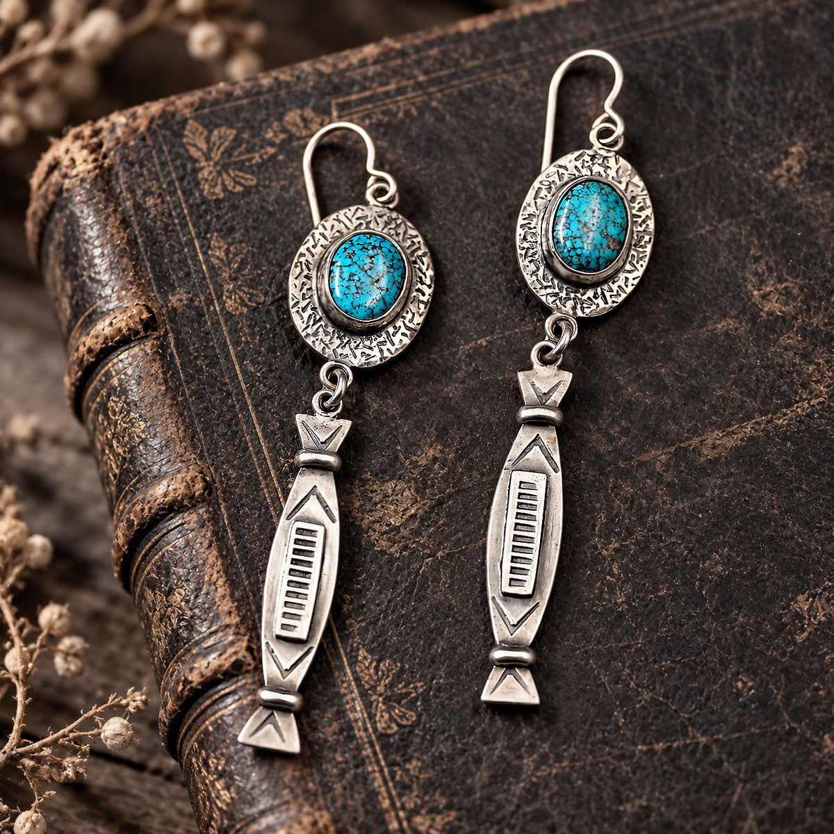 Turquoise oval cabochon sterling silver drop earrings with detailed arrow-shaped dangles