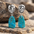 Turquoise and sterling silver dangle earrings with textured round caps and blue stone drops
