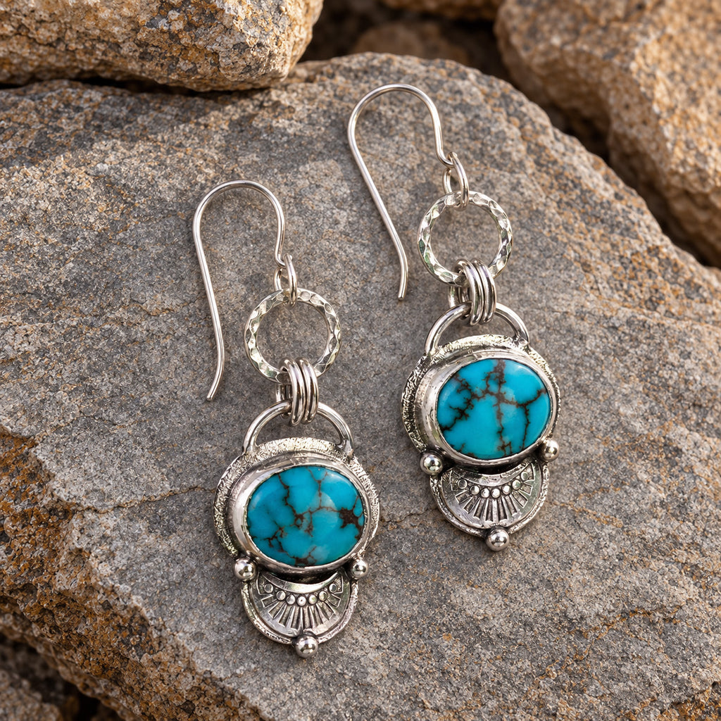 Turquoise stone drop earrings in antiqued sterling silver with circular dangling design
