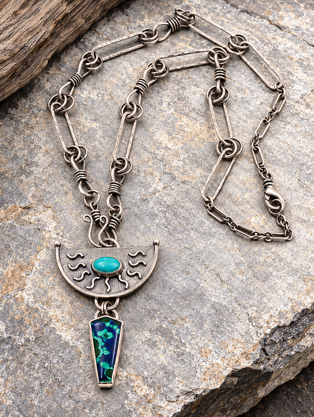 Sterling silver necklace with turquoise oval pendant and decorative crescent drop