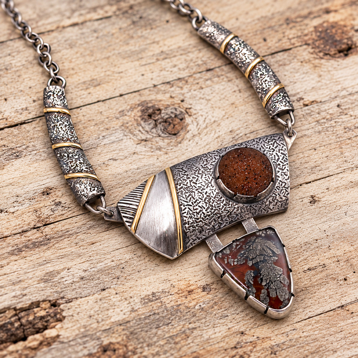 Silver chain necklace with textured links, gold accents, round brown stone and teardrop pendant