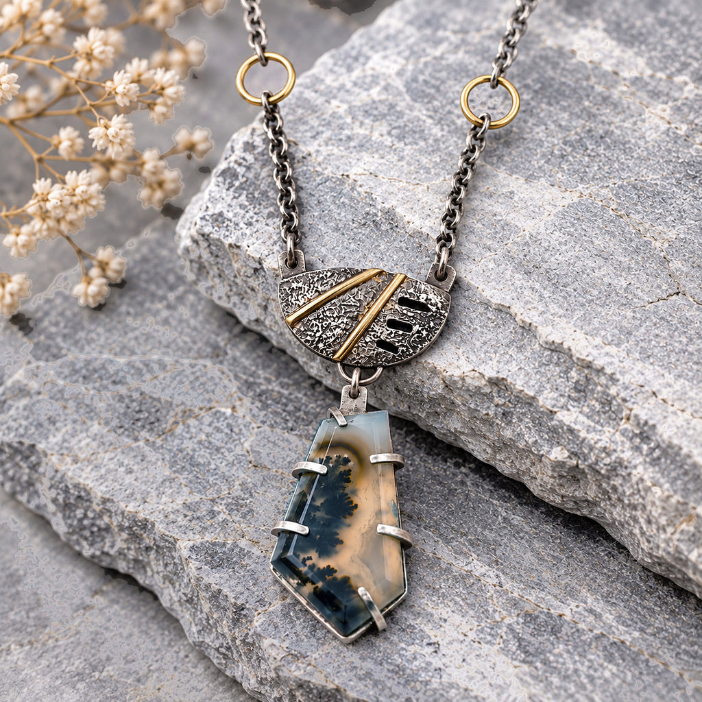 Sterling silver necklace with blue plume agate shield pendant, gold-tone frame