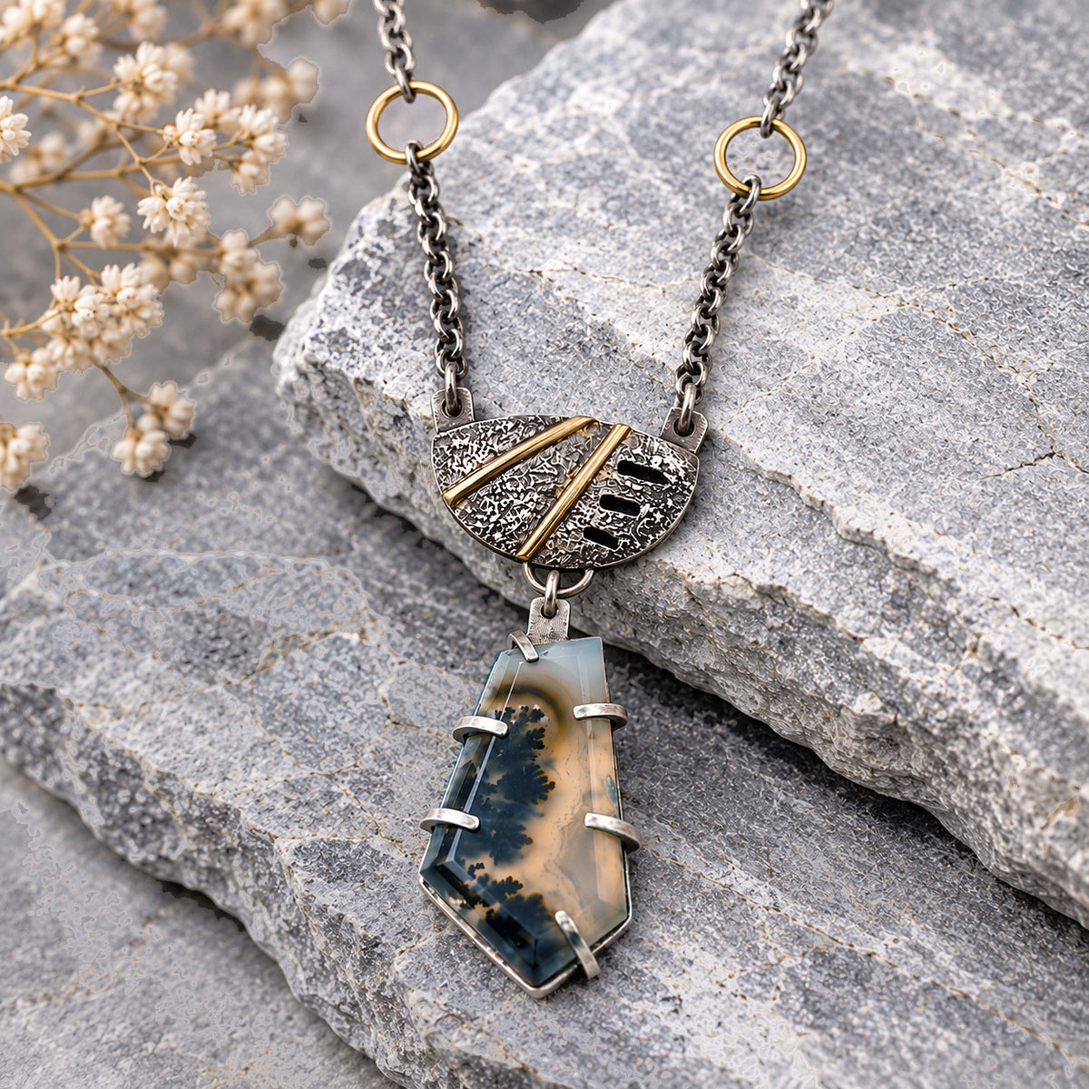 Sterling silver necklace with blue plume agate shield pendant, gold-tone frame