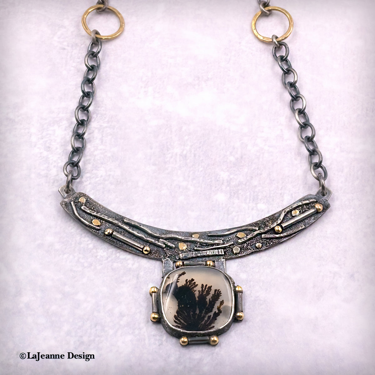 Dendritic agate pendant necklace with crescent bar and oval cabochon framed in gold-tone