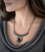 Dendritic agate pendant necklace with oval cabochon, crescent setting, and gold-tone accents