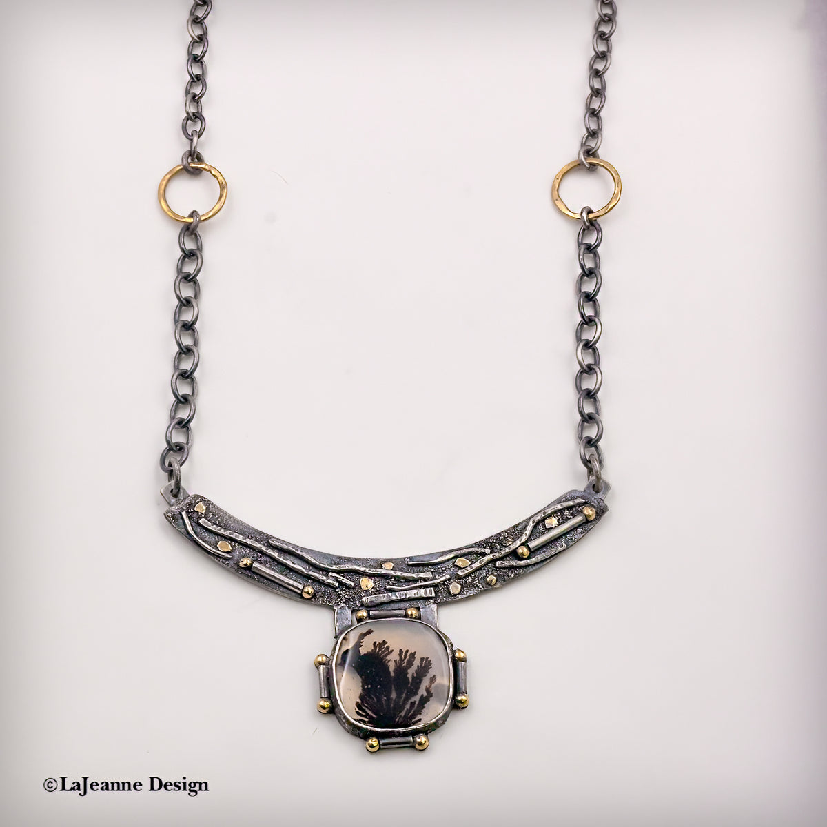 Dendritic agate pendant necklace with chain links and crescent bar design, gold-tone highlights
