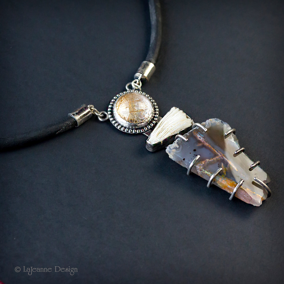 Gemstone pendant necklace with round cabochon and dark quartz cluster, black cord