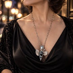 Sterling silver statement necklace on model with oval pearl-like stone and black pendant