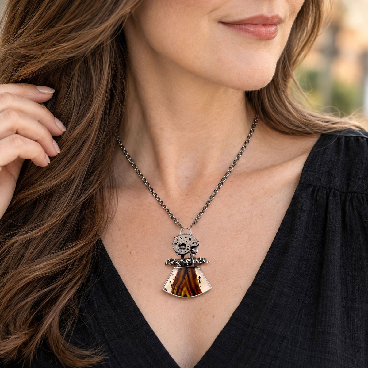Sterling silver necklace with dark bead chain and orange agate pendant