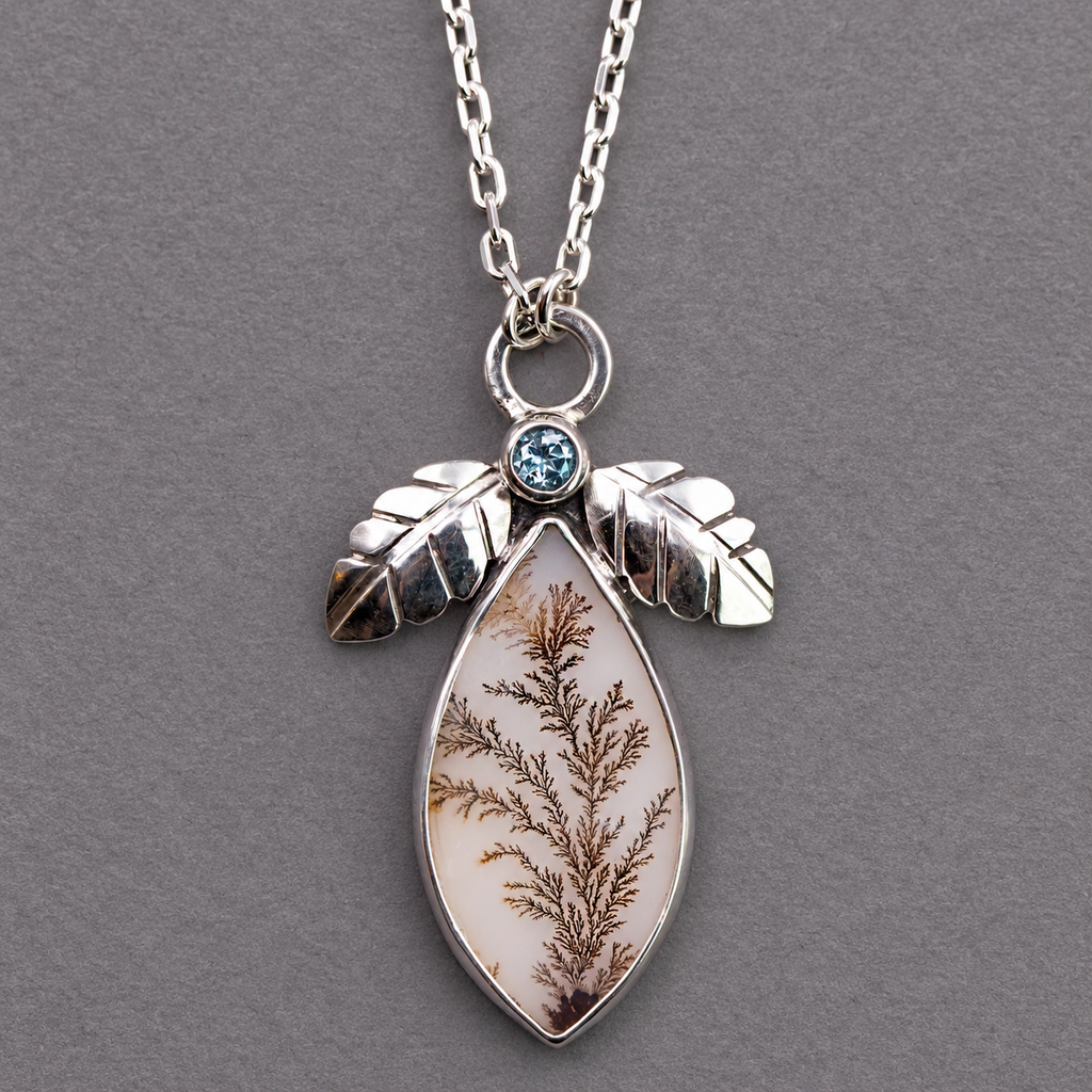 Sterling silver necklace pendant with blue topaz bezel and dendritic agate teardrop