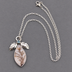 Sterling silver pendant necklace, teardrop agate with blue stone and leaflike accents