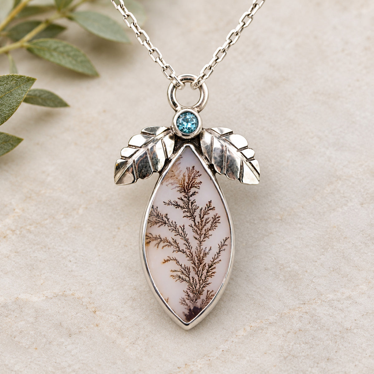 Sterling silver pendant necklace with oval dendritic agate and blue topaz cabochon