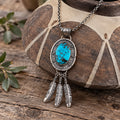 Turquoise oval pendant necklace in sterling silver with dangling feather charms