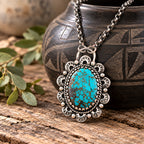 Turquoise and silver pendant necklace with ornate oval filigree setting