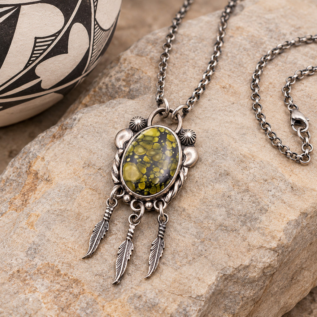Silver-tone feather pendant necklace with oval green/yellow gemstone cabochon and chain