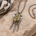 Silver-tone feather pendant necklace with oval green/yellow gemstone cabochon and chain