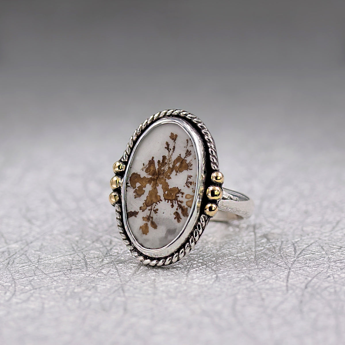 Oval dendritic agate ring on sterling silver band with rope bezel and gold bead accents