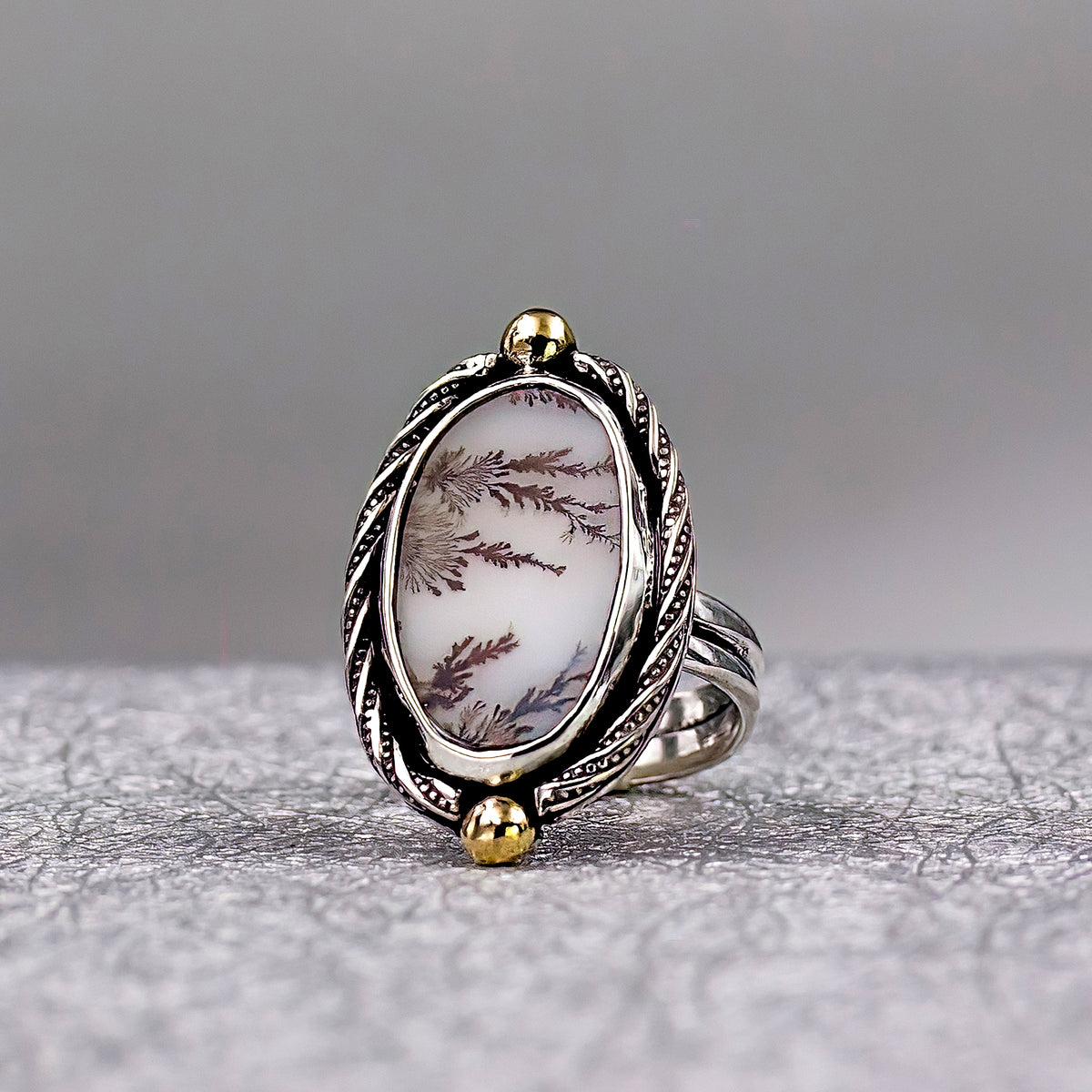 Sterling silver oval dendritic agate ring with tree-branch pattern, gold-tone details