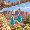 Sterling silver drop earrings with turquoise teardrop stones and blue accents
